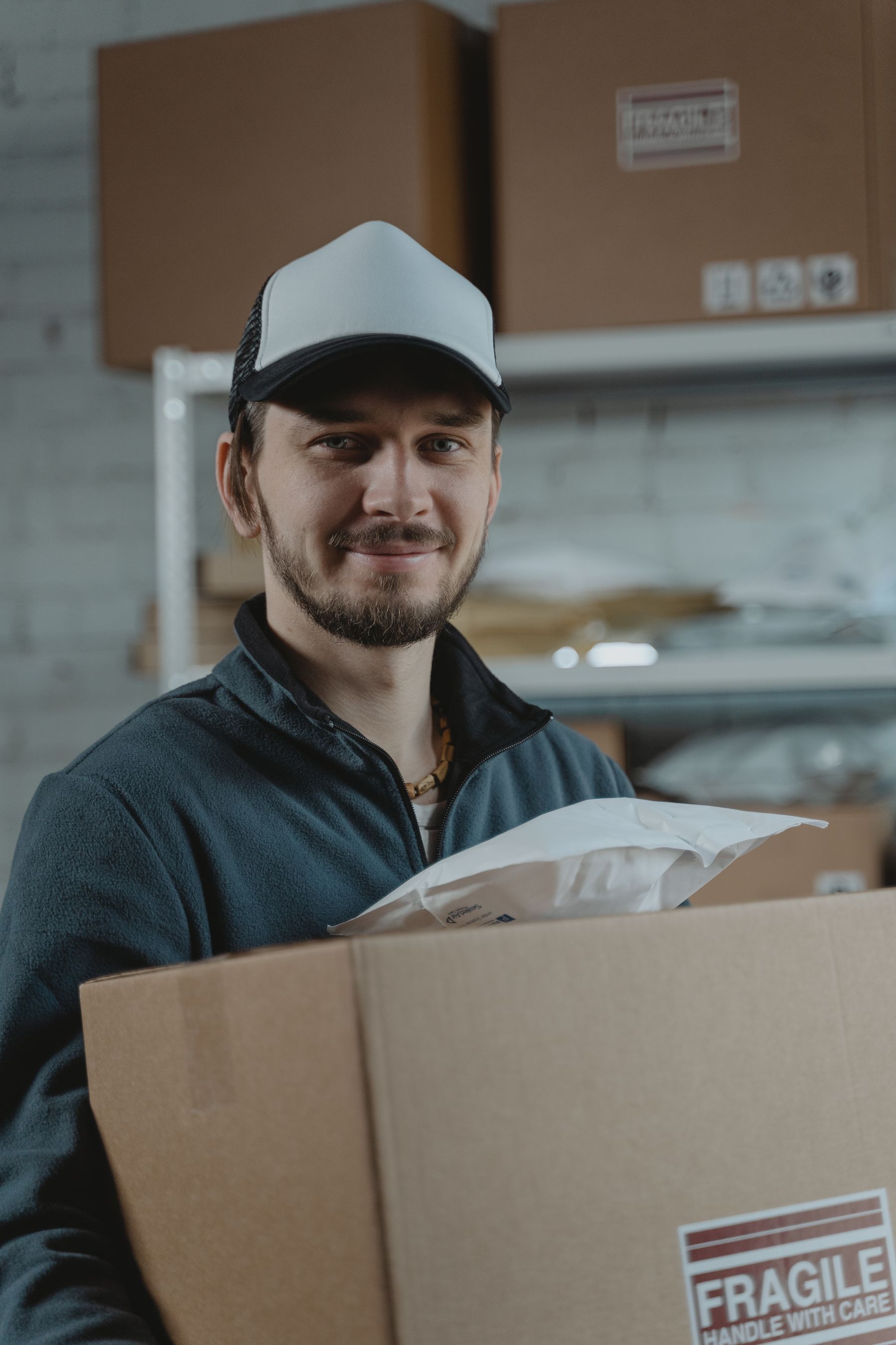 Warehouse employee holding a cardboard carton